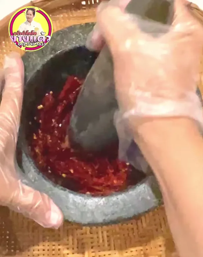 Pound the smaller tomato pieces with garlic, shallots, shrimp paste, and salt until fine.