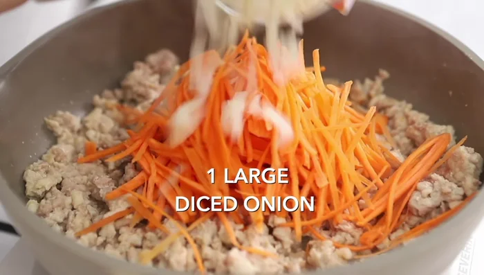 Add carrots (julienned or shredded), diced onion, and garlic. Cook until veggies soften.