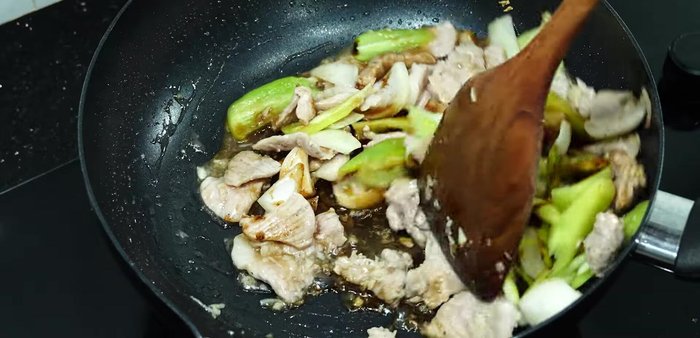 Stir-fry until bell peppers and onions are cooked.