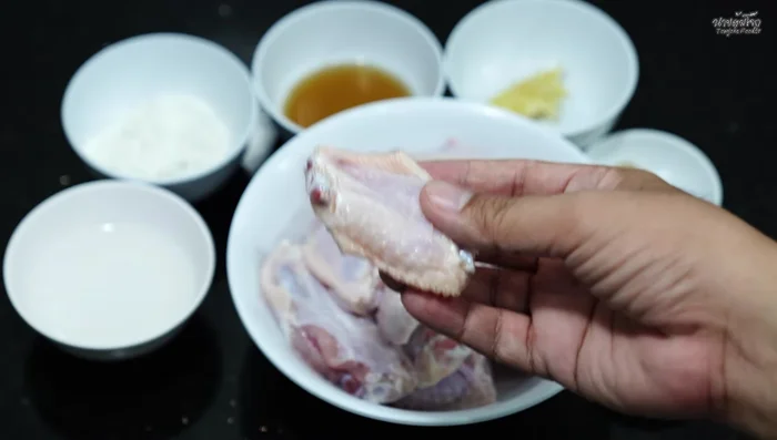 Mix together chicken seasoning powder, crushed garlic, chili pepper, fish sauce, and cold water.