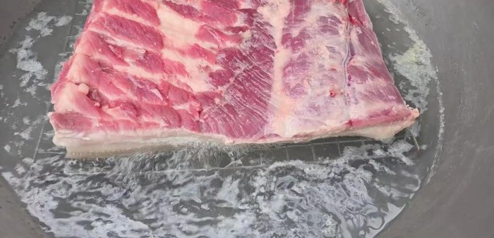 Boil the skin side of the pork belly for about 15 minutes. Dipping the skin in salt beforehand helps.