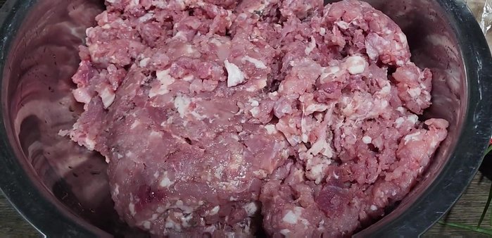 Combine ingredients: Add the prepared pork, fish sauce, salt, chili powder, and lime juice to a bowl. (This is a summary; the transcript indicates this process happens over time with tasting and adjustments)