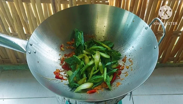 Stir-fry the kale: Add the seasoned kale to the pan and stir-fry over high heat until tender-crisp and brightly colored.