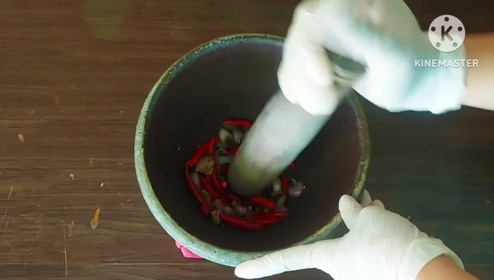 Pound the roasted chilies, shallots, and garlic until finely ground.