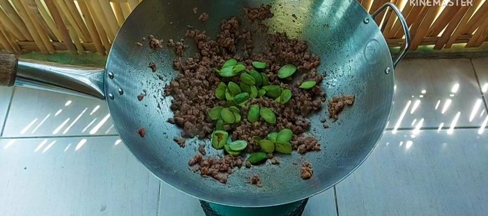 Add the stink beans (halved or whole, depending on preference) and stir-fry until slightly cooked.