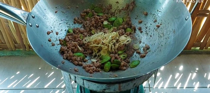 Add the chopped kaffir lime leaves and chilies (optional).