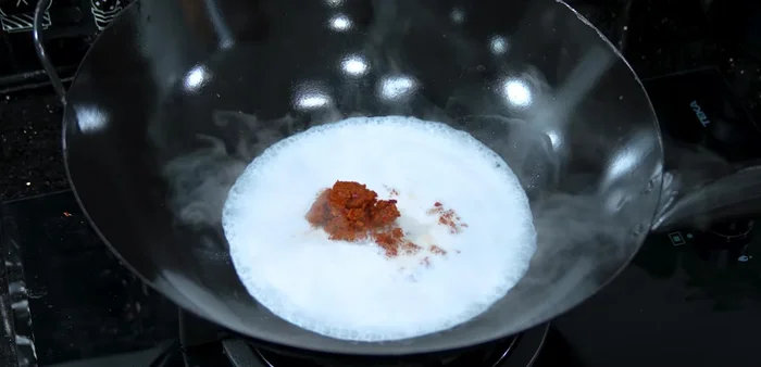 Add red curry paste and shrimp paste; stir-fry until well combined.