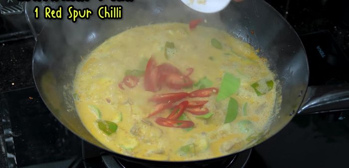 Add the remaining kaffir lime leaves and red chili peppers.