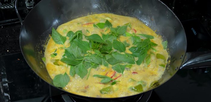 Add basil leaves and stir-fry over high heat until cooked. High heat prevents blackening.
