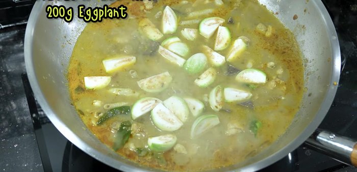 Add the eggplant and cherry tomatoes to the boiling curry.