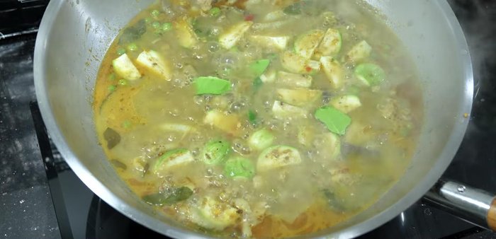 Add the remaining kaffir lime leaves and chopped chili pepper.