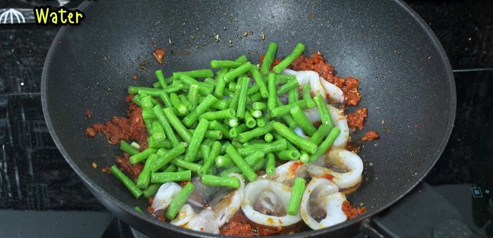Add the blanched yardlong beans and a little water. Stir-fry until everything is well combined.