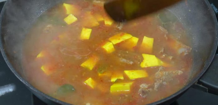 Add the pumpkin and continue to simmer until tender (color changes to a golden hue).