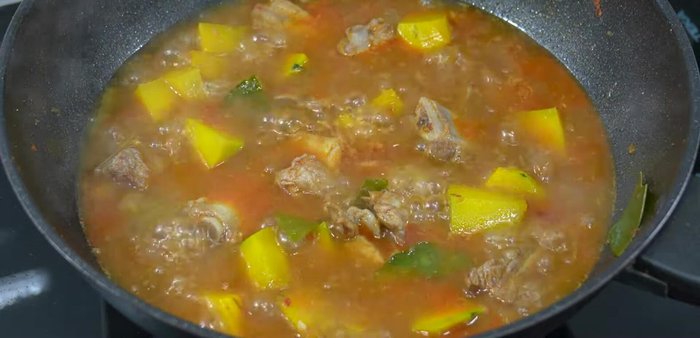 Increase heat to high. Add the remaining kaffir lime leaves, chili peppers, and bell peppers. Cook until heated through.
