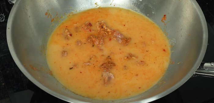 Add the second pressing of coconut milk, increase the heat, and bring the curry to a boil.