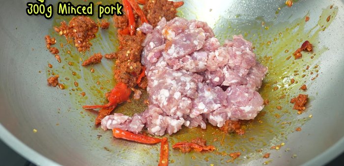 Add the minced pork and stir-fry until cooked.