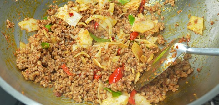 Season with fish sauce, seasoning powder, and stir-fry until well-blended.