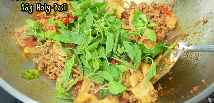 Add basil leaves and stir-fry briefly until fragrant.