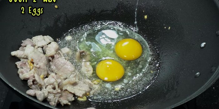 Add 2 eggs and stir-fry until set, then scramble.