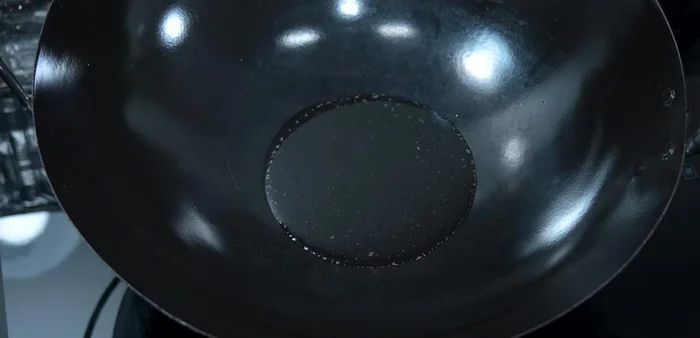 Heat soybean oil in a wok or large frying pan until very hot (204.44).
