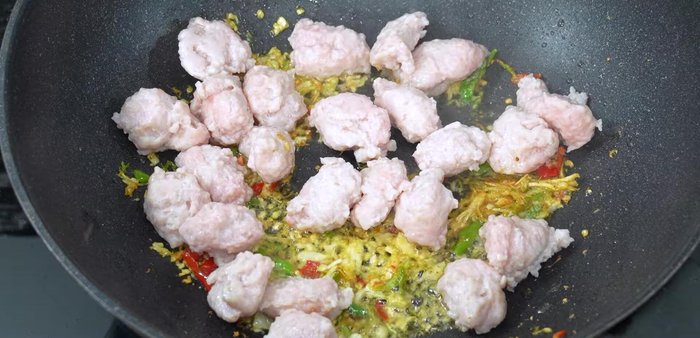 Add the blanched bouncy pork to the wok.
