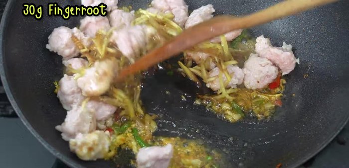 Add sliced galangal and stir-fry until fragrant.