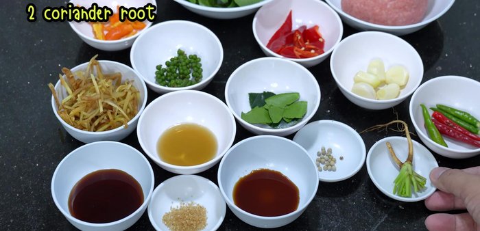 Pound together garlic, chili peppers, coriander root, and peppercorns to make a paste.