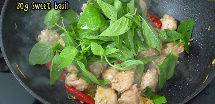 Stir in basil leaves and cook quickly over high heat until fragrant and bright green.