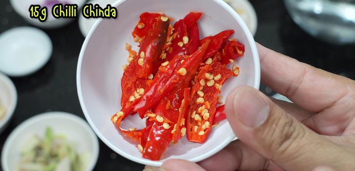 Crush shallots and pound chili peppers.
