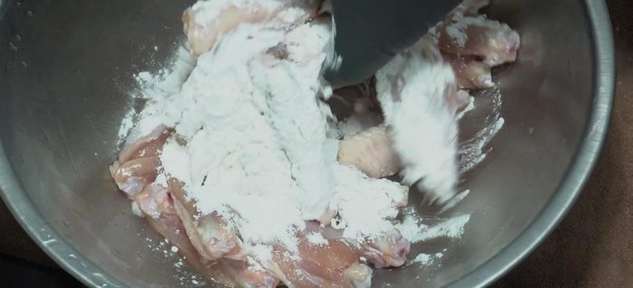 Add crispy flour to the marinated chicken wings and mix until well coated.