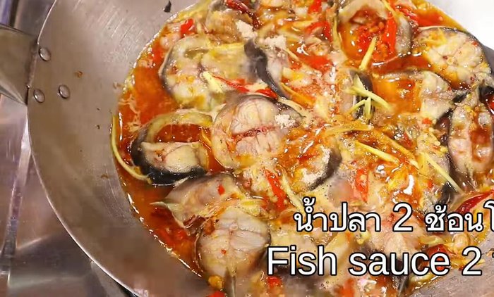 Add the catfish fillets and stir-fry until cooked through and slightly crispy.