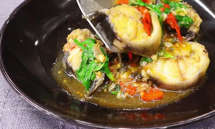 Add soy sauce, fish sauce, oyster sauce, and sugar. Stir well to combine and coat the catfish.