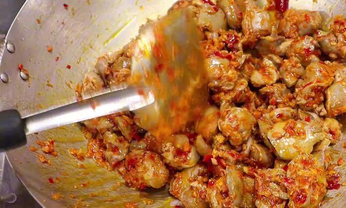 Continue stir-frying until the sauce thickens and the giblets are tender. (implied)
