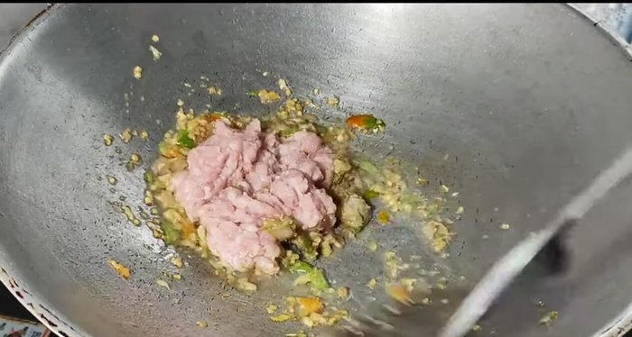 Add the minced pork and stir-fry until cooked.
