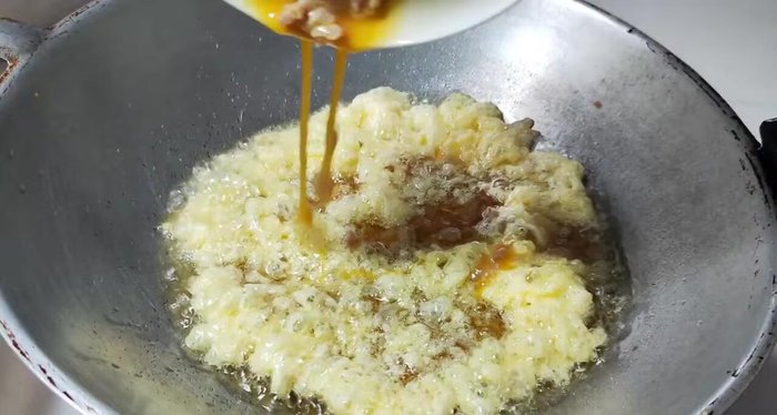 Pour the egg mixture evenly across the pan, filling any gaps.