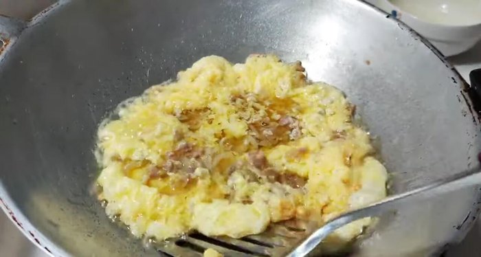 Use a spatula to gently lift the edges of the omelet, allowing uncooked egg to flow underneath.