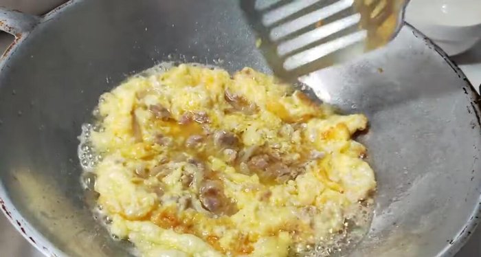 Continue cooking until the omelet is set and golden brown on both sides.