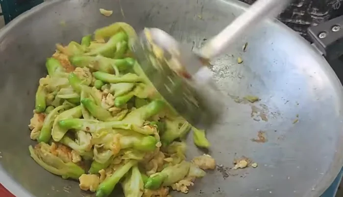Stir-fry until the kale flowers are cooked and slightly dry. Add water if needed.