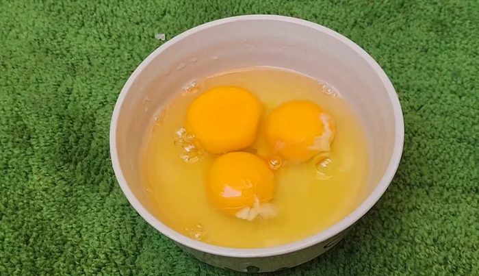 Crack eggs into a bowl.