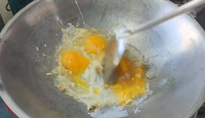 Add eggs and stir-fry until cooked, breaking them up with a spatula.