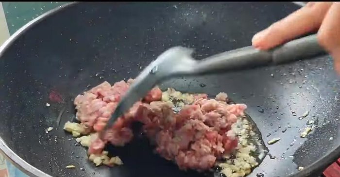 Add minced pork and stir-fry until cooked.