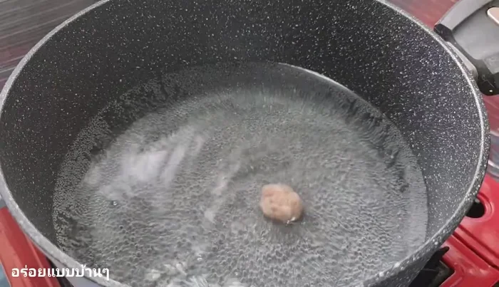 Once the water is hot, add the seasoned minced pork. Shape it into small meatballs or simply add it to the pot.