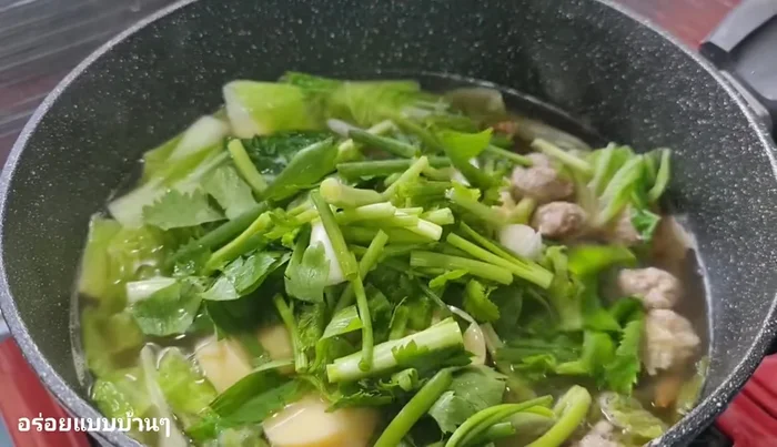 Add coriander and spring onions. Stir for a moment to combine the ingredients.