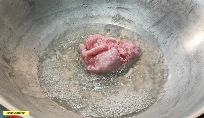 Cook minced pork in a frying pan until browned.
