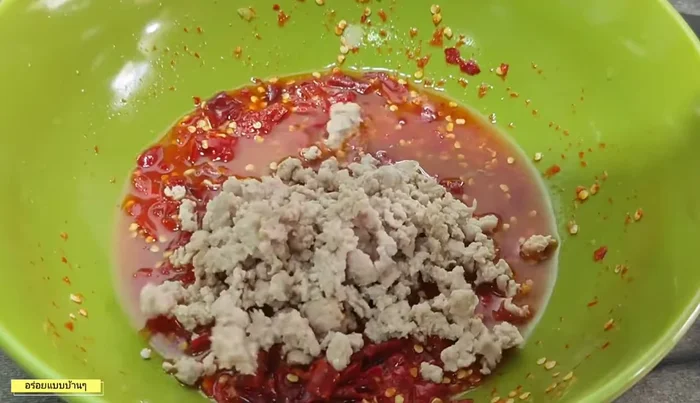Add cooked minced pork to the dressing and mix well.