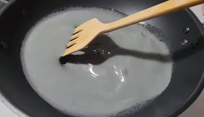 Cook the mixture over very low heat, stirring constantly until it thickens into a solid mass (about 1 hour).