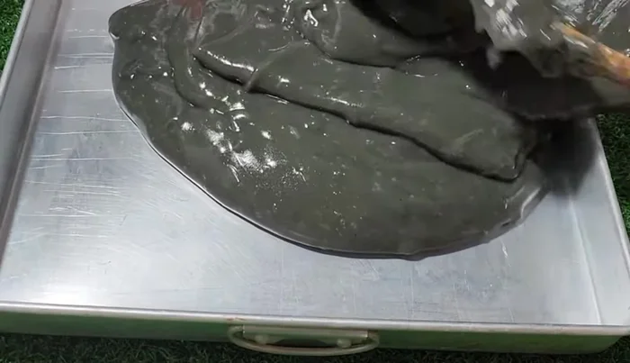 Pour the mixture into a 10x10 tray and smooth the surface.
