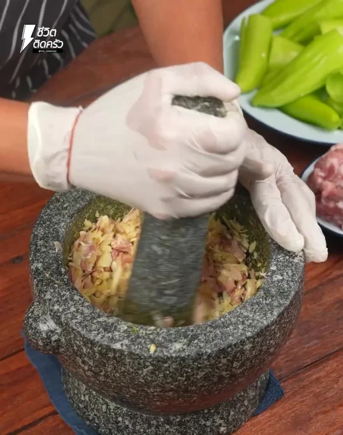 Pound garlic coarsely in a mortar and set aside. (60.079)