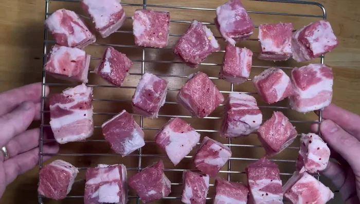 Place the seasoned pork belly on a wire rack for easier handling in the smoker.