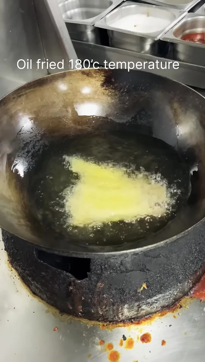 Deep fry the spring rolls in oil at 180°C for 2-3 minutes, or until golden brown.
